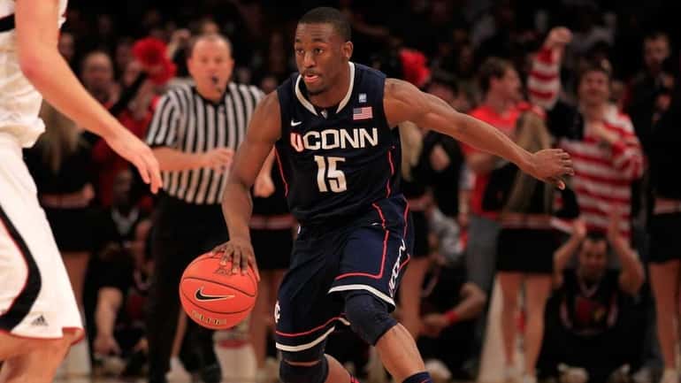 Kemba Walker #15 of the Connecticut Huskies dribbles up court...