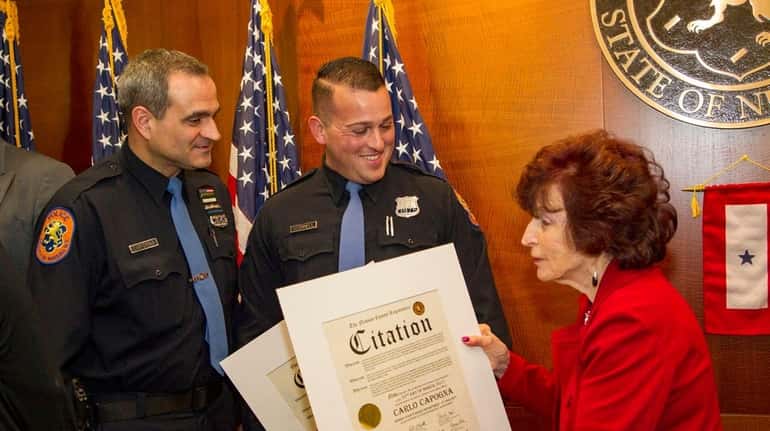 Nassau Police officers Carlo Capogna and Nathan O'Connell receive citations...