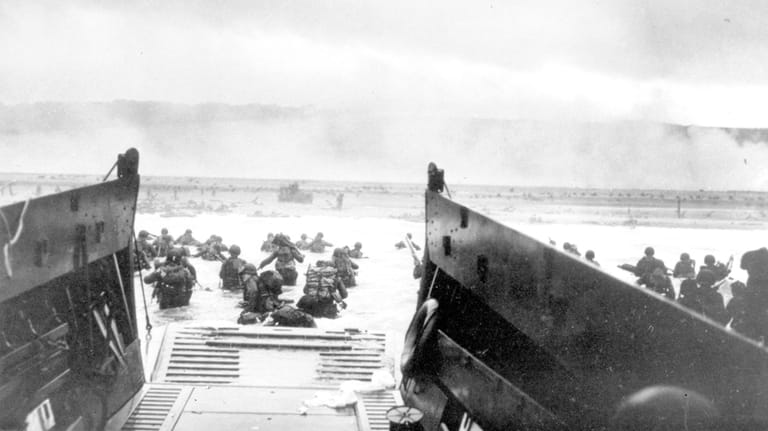 U.S troops wade ashore at Normandy, France on D-Day, June...