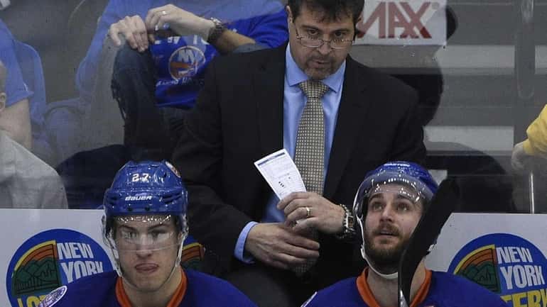 New York Islanders head coach Jack Capuano looks on against...