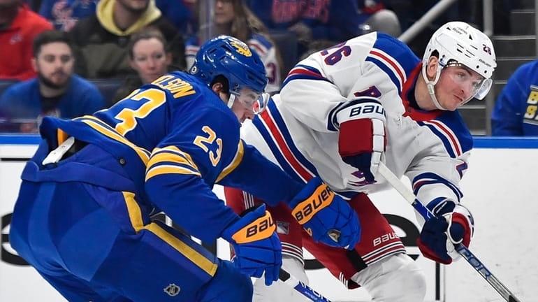 Rangers left wing Jimmy Vesey, right, shoots on goal while...