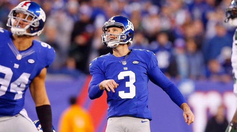 Giants' Josh Brown watches his missed field goal in overtime...
