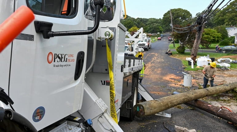 PSEG Long Island crews work to restore power on Brunswick Road...