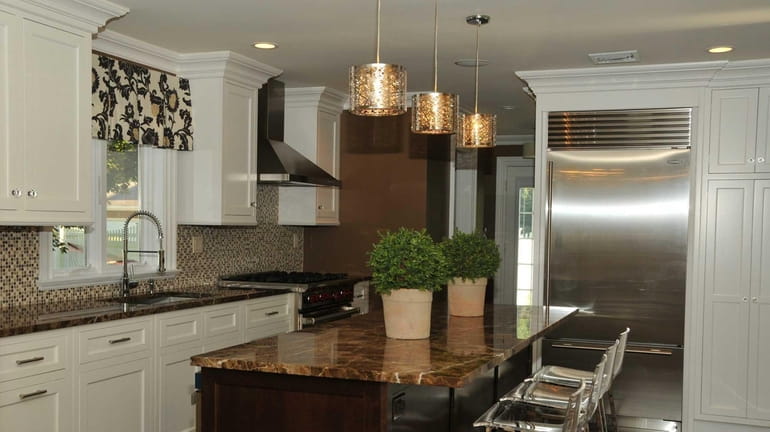 The renovated kitchen is shown inside an Oyster Bay home.