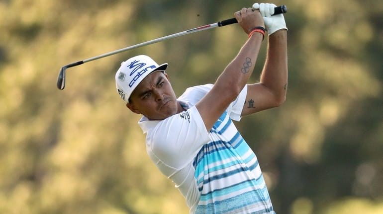 Rickie Fowler plays a shot on the 17th hole during...