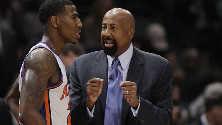 Knicks head coach Mike Woodson talks to Iman Shumpert (21)...