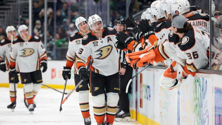 Anaheim Ducks right wing Jakob Silfverberg, center, is congratulated for...