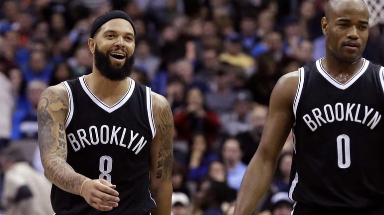 Brooklyn Nets' Deron Williams walks with teammate Jarrett Jack to...