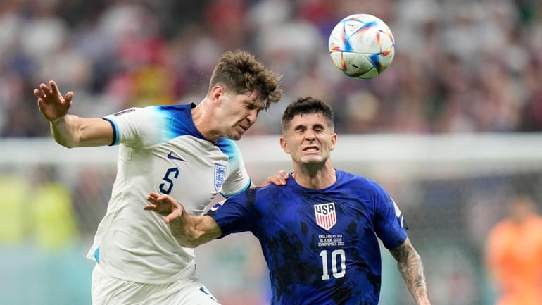 England's John Stones vies for the ball with Christian Pulisic...