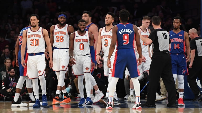 Knicks players look on against the Pistons during the second...