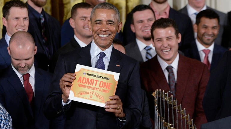 President Barack Obama receives a lifetime ticket as he welcomes...