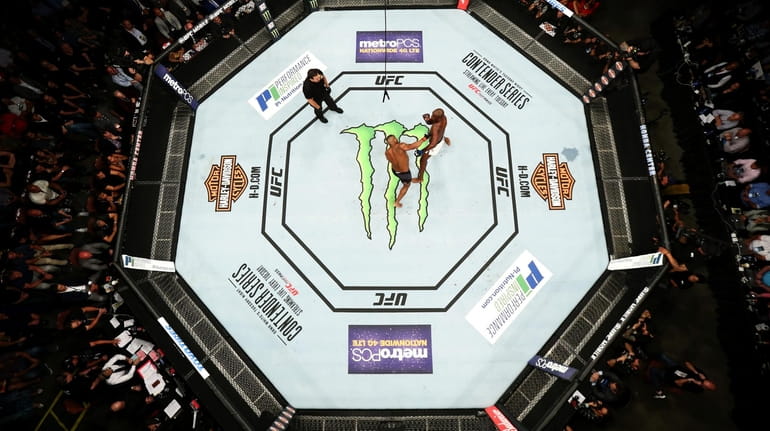 An overhead view of the Octagon as Jon Jones punches...