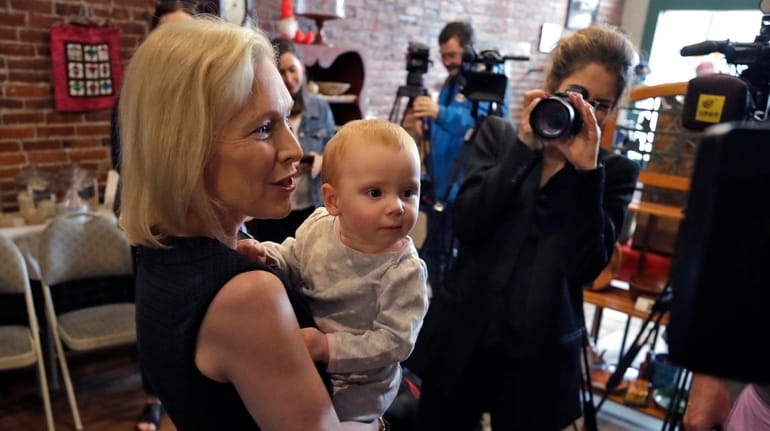 Democratic presidential candidate Sen. Kirsten Gillibrand (D-N.Y.) holds Alex Murphy at...