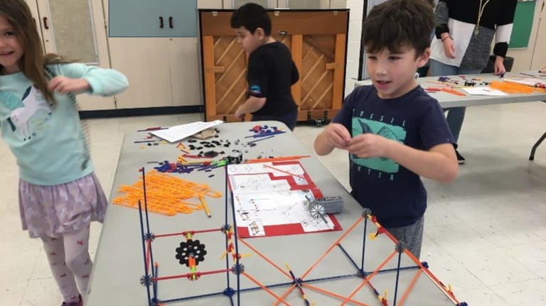 Second-graders at the Montauk School create mini roller coasters as part...