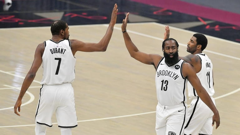 The Brooklyn Nets' Kevin Durant (7), James Harden (13) and...