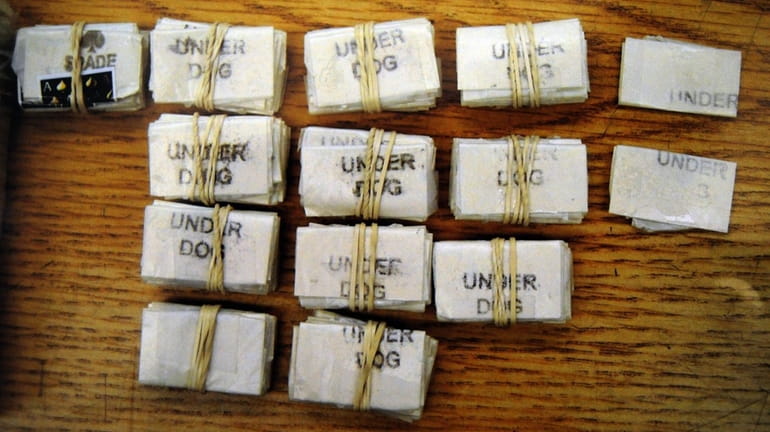 An undated Suffolk County police evidence photo of heroin confiscated...