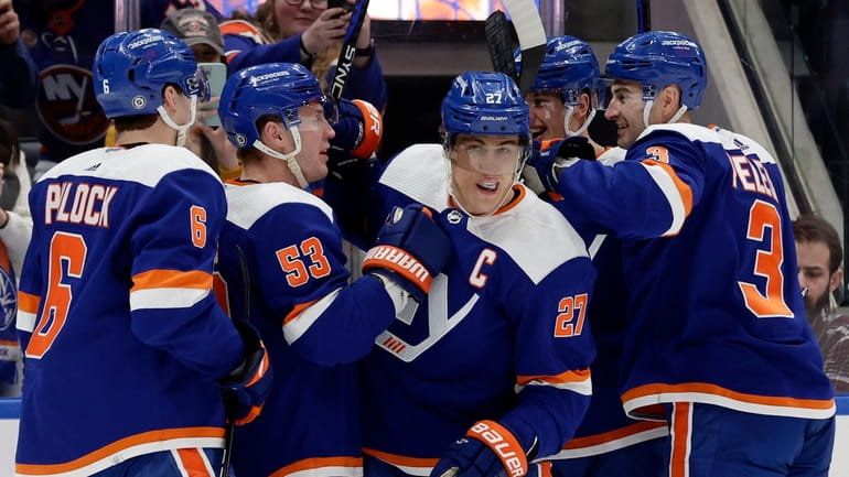 Anders Lee of the Islanders celebrates his first goal of the...