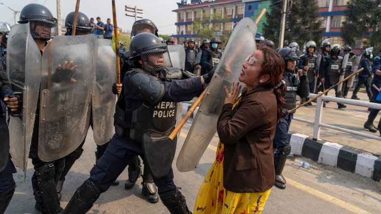 Policemen baton charge supporters of Rastriya Prajatantra Party, or national...