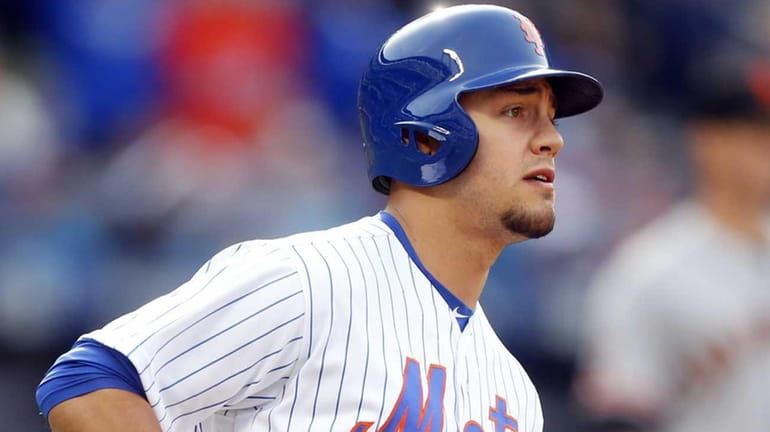 Michael Conforto #30 of the New York Mets runs out...