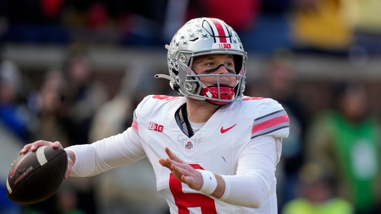 Ohio State quarterback Kyle McCord throws during the first half...