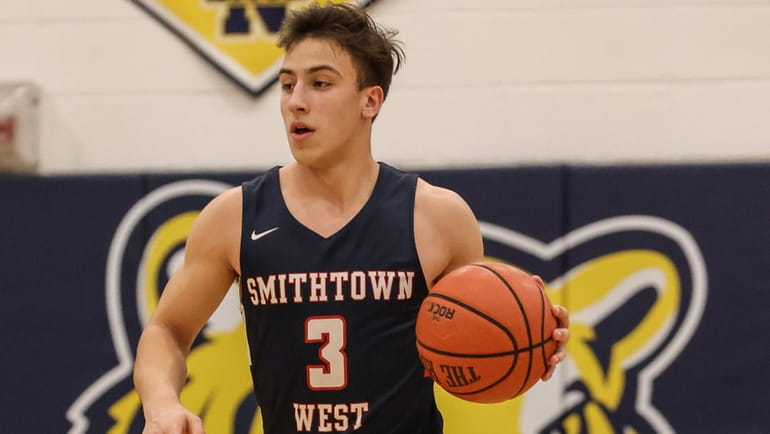 Smithtown West's Lorenzo Rappa brings the ball downcourt during a...