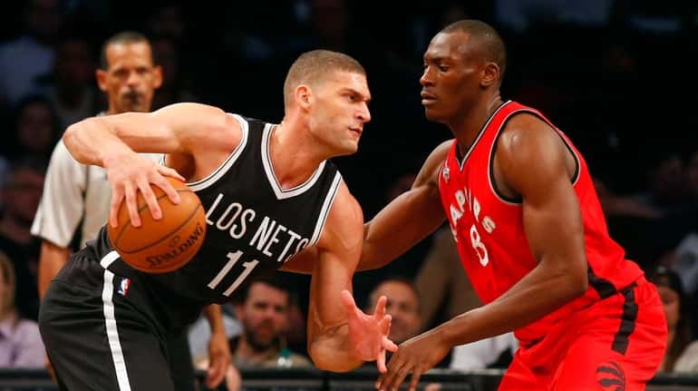 Brook Lopez of the Brooklyn Nets looks to drive against...