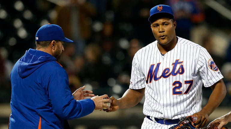 Jeurys Familia of the Mets hands the ball to manager Mickey...