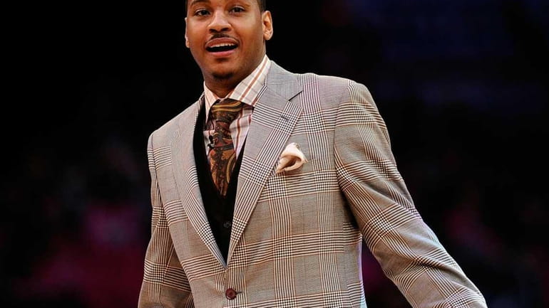 Carmelo Anthony of the Denver Nuggets reacts as he takes...