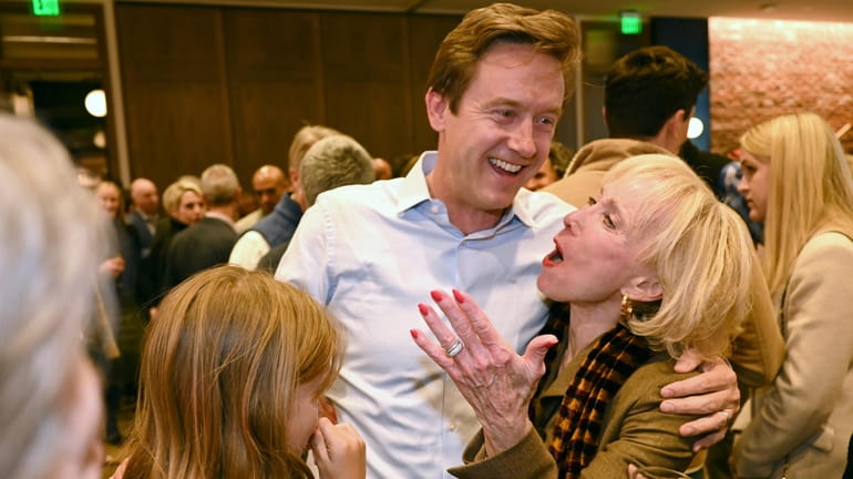 Mike Johnston, a Denver mayoral candidate, hugs Cheryl Holt and...