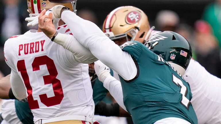 Eagles linebacker Haason Reddick, right, causes a fumble by 49ers quarterback...