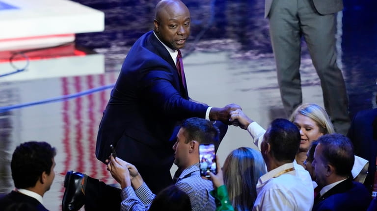 Republican presidential candidate Sen. Tim Scott, R-S.C., greets people after...