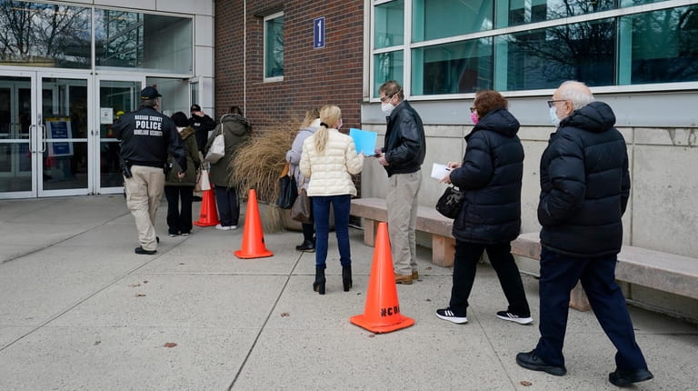 People lined up Tuesday at Nassau County's first COVID-19 vaccination site,...