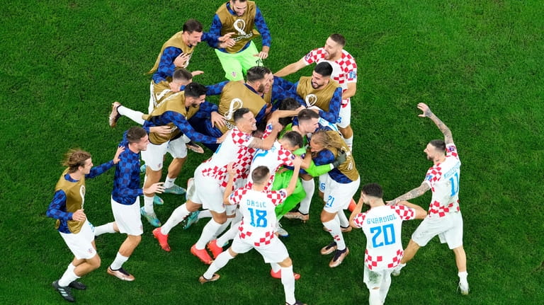 Croatia's players celebrate winning the World Cup quarterfinal soccer match...