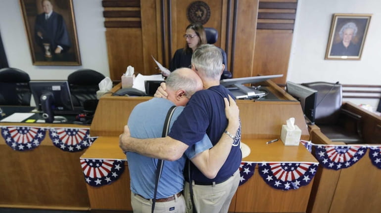 Gerald Gafford, right, comforts his partner of 28 years, Jeff...