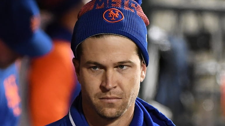 New York Mets pitcher Jacob deGrom in the dugout against...