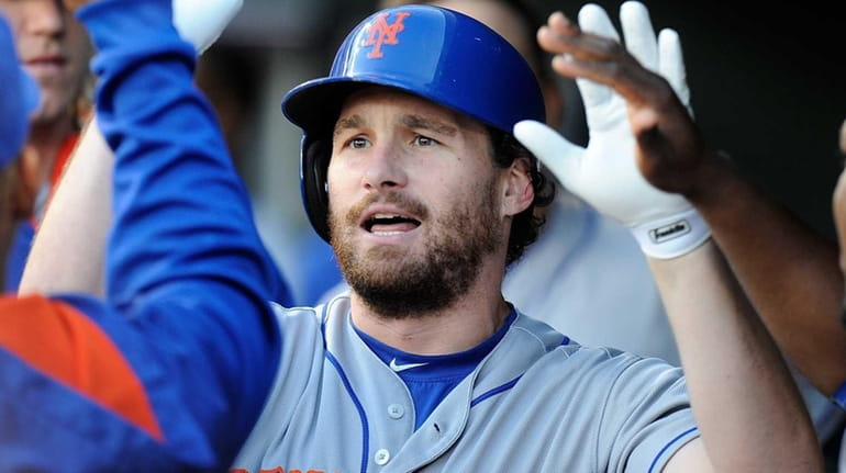 Daniel Murphy of the New York Mets celebrates with teammates...