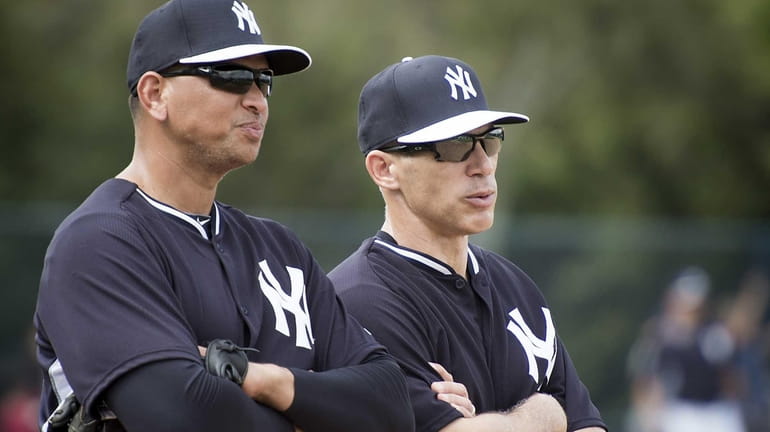 Yankees third baseman Alex Rodriguez talks with manager Joe Girardi...