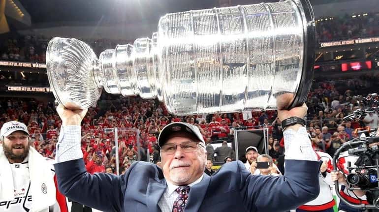 Coach Barry Trotz of the Washington Capitals hoists the Stanley...