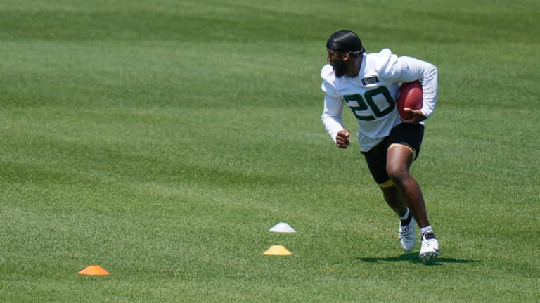 New York Jets' Breece Hall participates in a drill at...