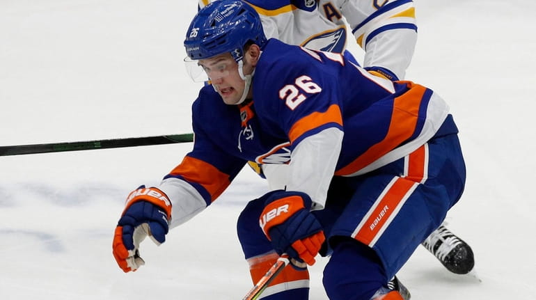 Oliver Wahlstrom #26 of the Islanders carries the puck past...