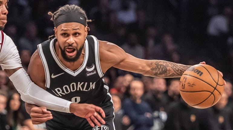 The Nets' Patty Mills driving against Darius Garland of the...