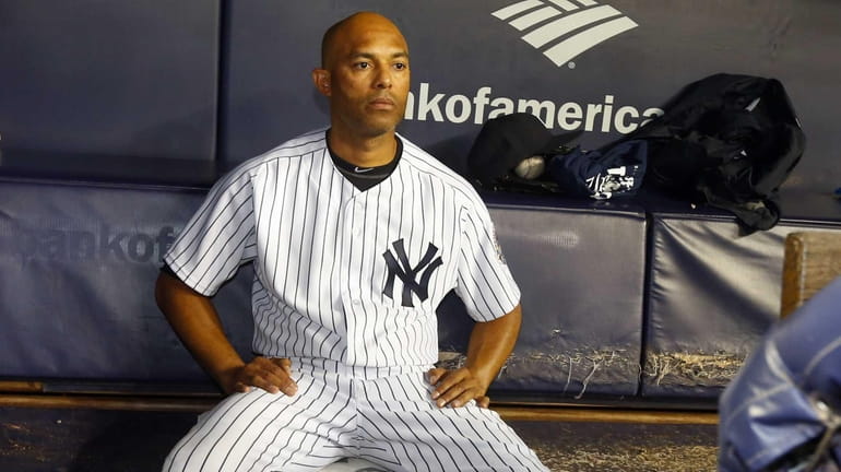 Mariano Rivera of the Yankees sits alone in the dugout...