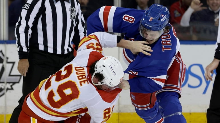 Jacob Trouba of the Rangers fights Dillon Dube of the Flames late...