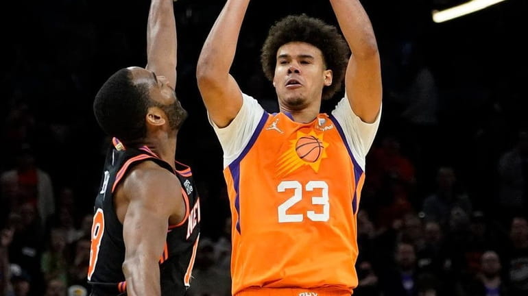 Suns forward Cameron Johnson shoots the game-winning three pointer over...