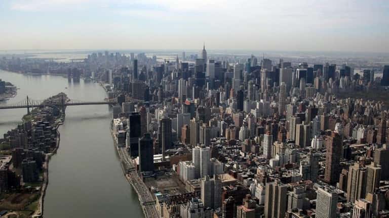 An aerial of Manhattan, the East River and Roosevelt Island...