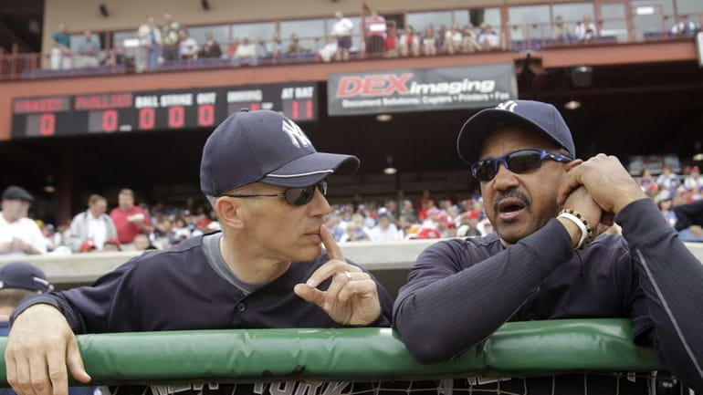 New York Yankees manager Joe Girardi, left, talks to bench...