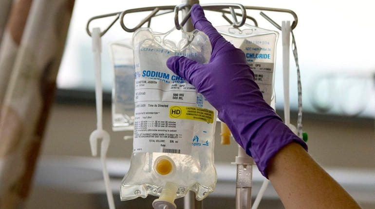 A nurse places a patient's chemotherapy medication on an intravenous...