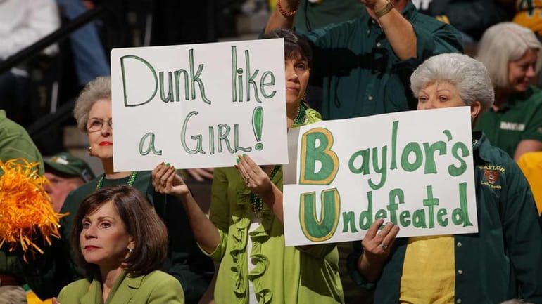Fans of the Baylor Bears hold up signs in support...