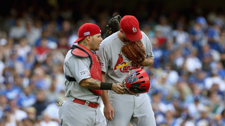 St. Louis Cardinals starting pitcher Adam Wainwright and catcher Yadier...