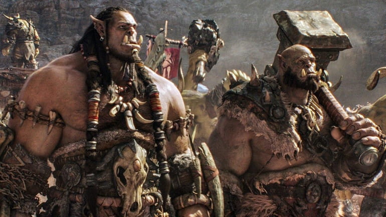Durotan (voiced by Toby Kebbell), left, and Orgrim (voiced by...